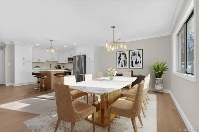a view of a dining room with furniture and chandelier