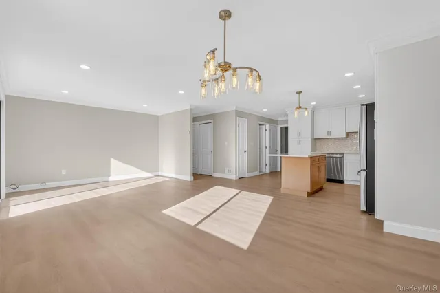 a view of a kitchen with a sink cabinet and a chandelier