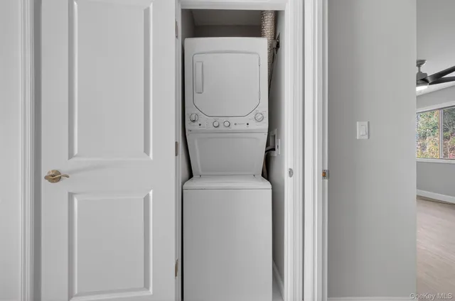 a view of a hallway with washer and dryer