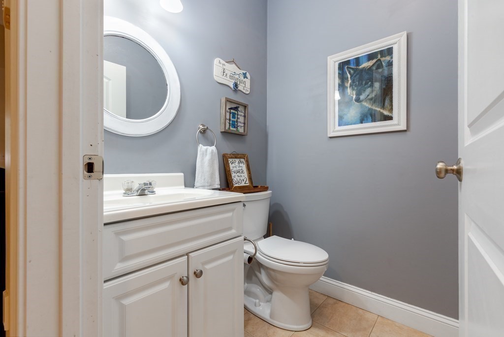 2 Charles Ridge Road, Unit D Littleton, MA 01460 - Photo 8 of 30 a bathroom with a toilet sink vanity and mirror