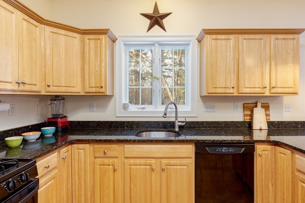 2 Charles Ridge Road, Unit D Littleton, MA 01460 - Photo 10 of 30 a kitchen with stainless steel appliances granite countertop a stove a sink and a granite counter tops