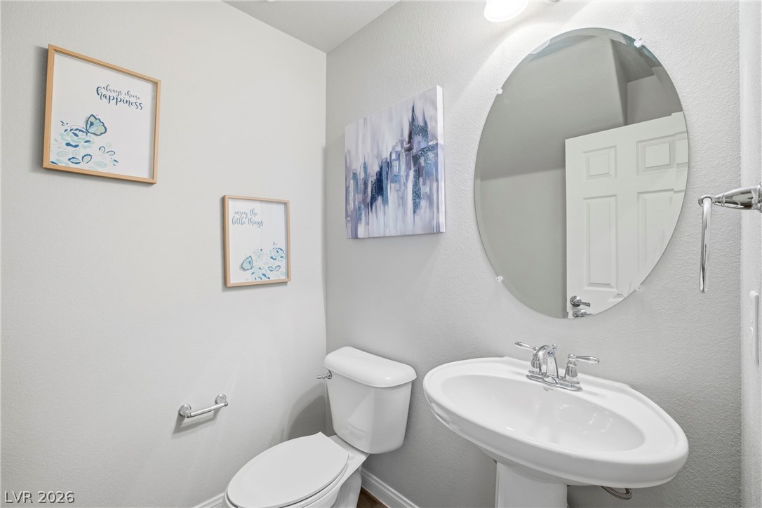 5953 Graystone Ridge Avenue Las Vegas, NV 89141 - Photo 15 of 51 Downstairs Bathroom featuring toilet and a textured wall