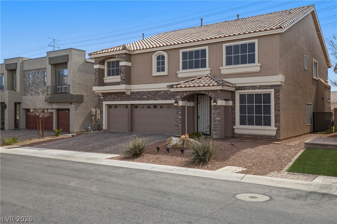 5953 Graystone Ridge Avenue Las Vegas, NV 89141 - Photo 2 of 51 Mediterranean / spanish home featuring a garage, stucco siding, driveway, and a tile roof