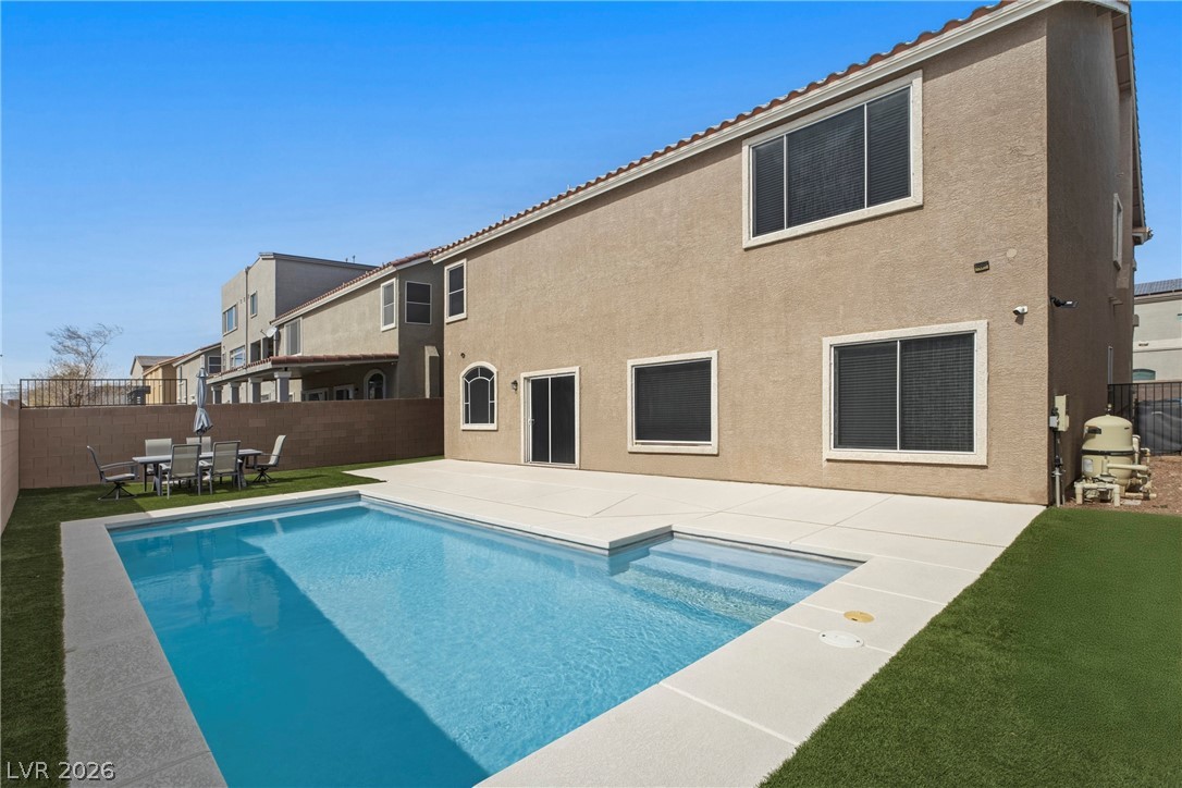 5953 Graystone Ridge Avenue Las Vegas, NV 89141 - Photo 33 of 51 Rear view of property with a patio area, a fenced backyard, stucco siding, outdoor dining space, and a tile roof