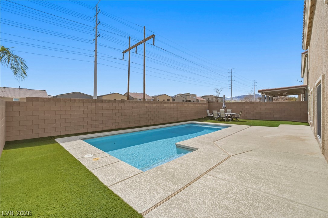 5953 Graystone Ridge Avenue Las Vegas, NV 89141 - Photo 34 of 51 View of swimming pool with patio surround, a fenced backyard, and outdoor dining area