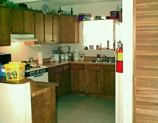 a kitchen with sink cabinets and appliances