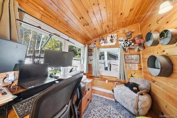 a living room with furniture a flat screen tv and a floor to ceiling window
