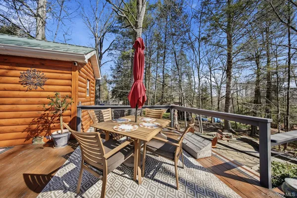 a view of a chairs and table on the deck