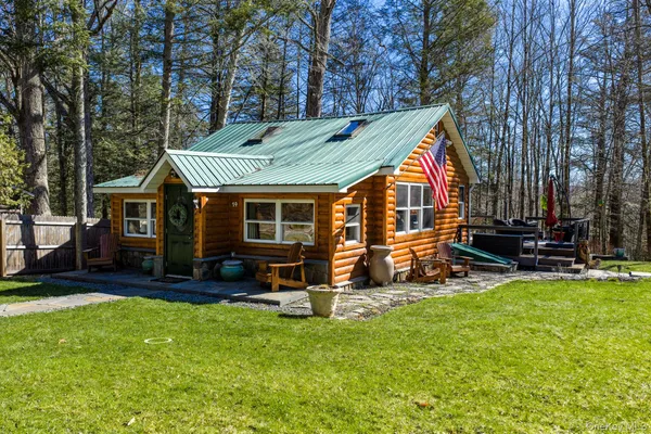 a view of a house with a yard and sitting area