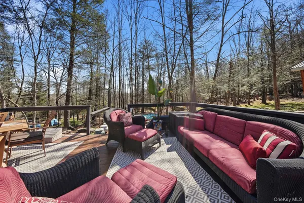 a balcony with wooden floor and outdoor seating