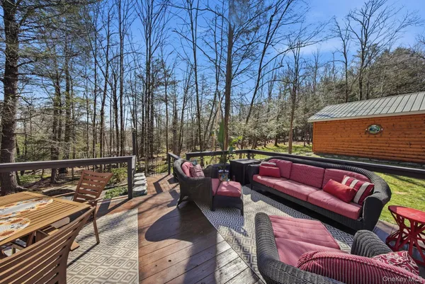 a outdoor sitting area with furniture and wooden floor