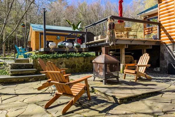 a view of a patio with table and chairs and potted plants