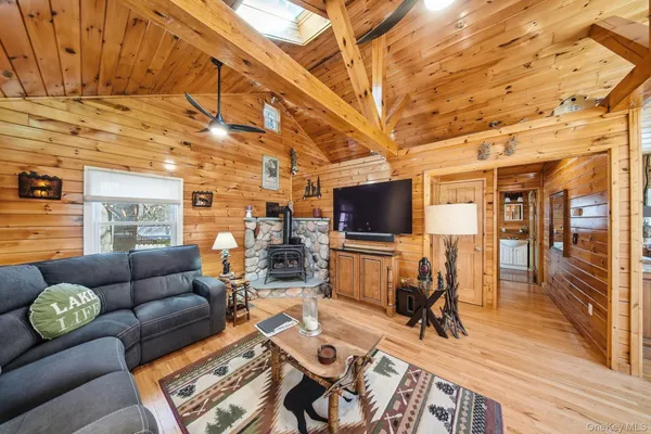 a living room with furniture a flat screen tv and a table