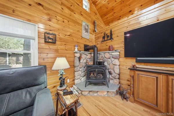 a view of a patio with table and chairs with wooden floor and fence