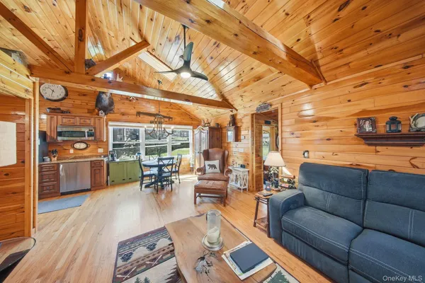 a living room with furniture and a view of kitchen