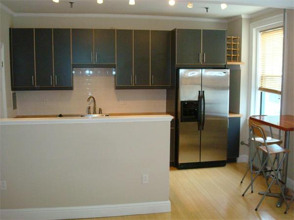 a kitchen with a refrigerator and cabinets