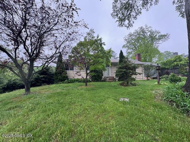 62 Byram Shore Road Greenwich, CT 06830 - Photo 5 of 7 a view of a backyard with large trees