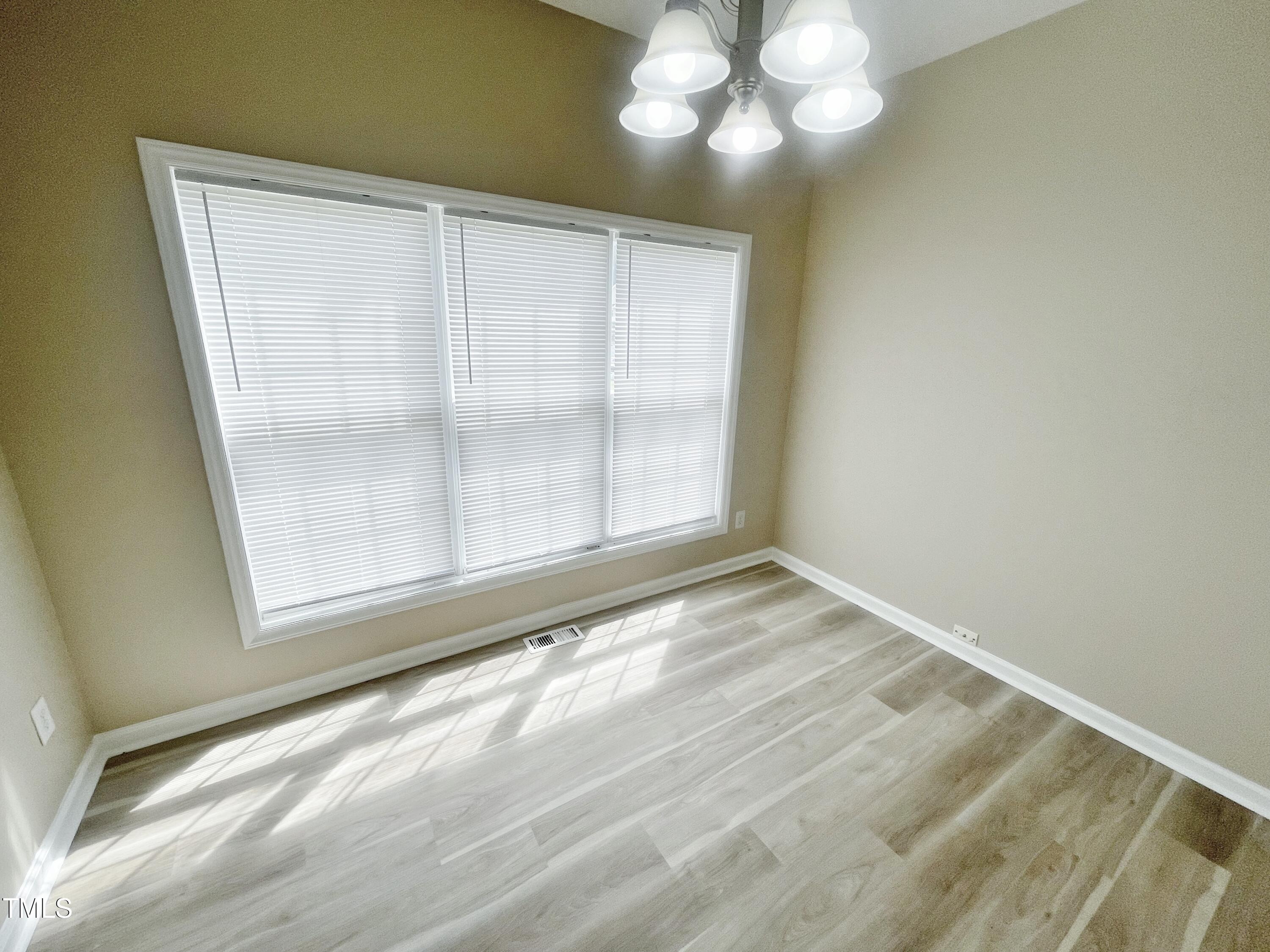 4212 Beacon Crest Way Raleigh, NC 27604 - Photo 8 of 31 a view of an empty room with a window