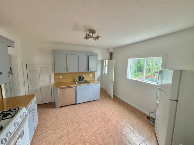 a large kitchen with a stove a refrigerator and a stove