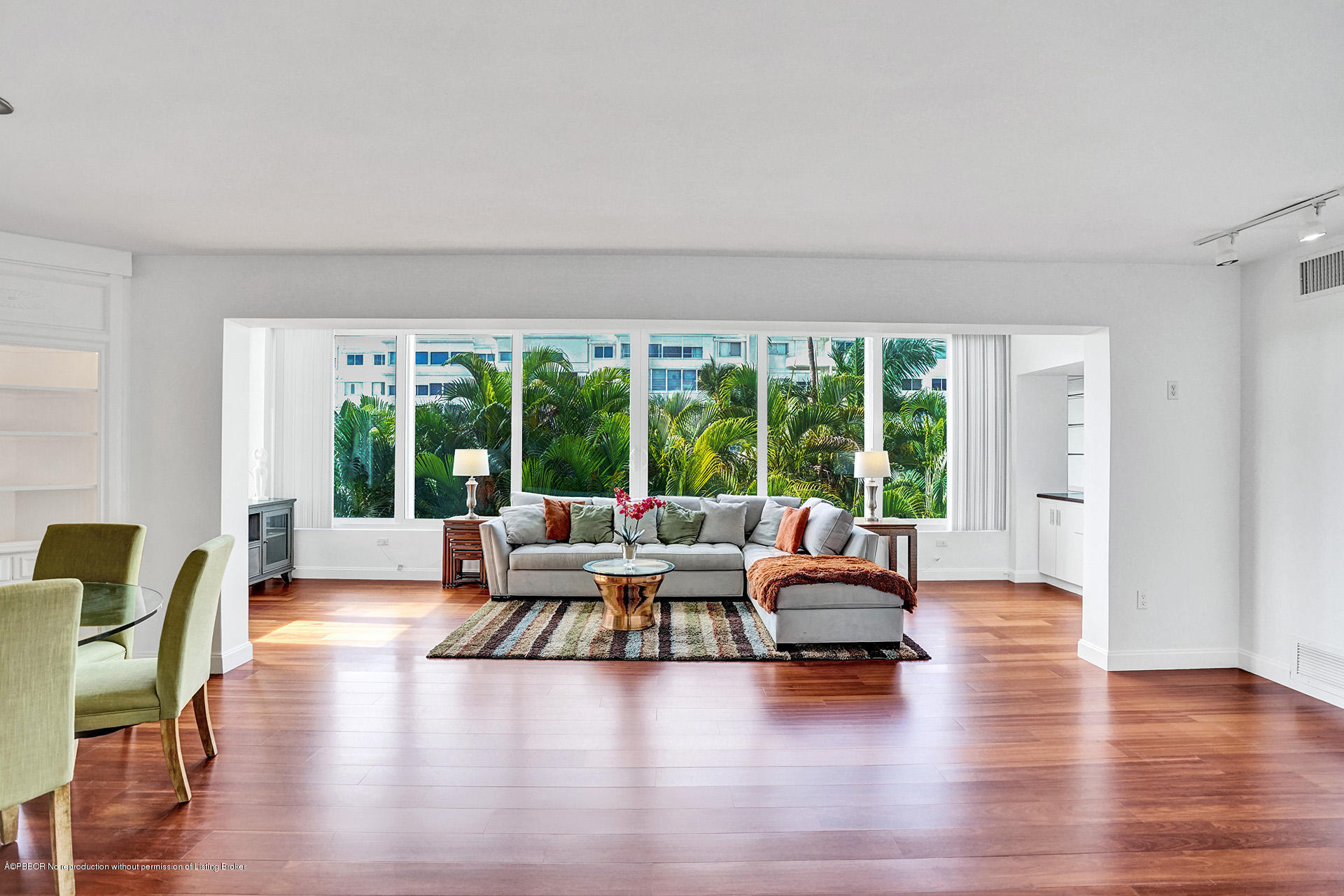a living room with furniture and large windows