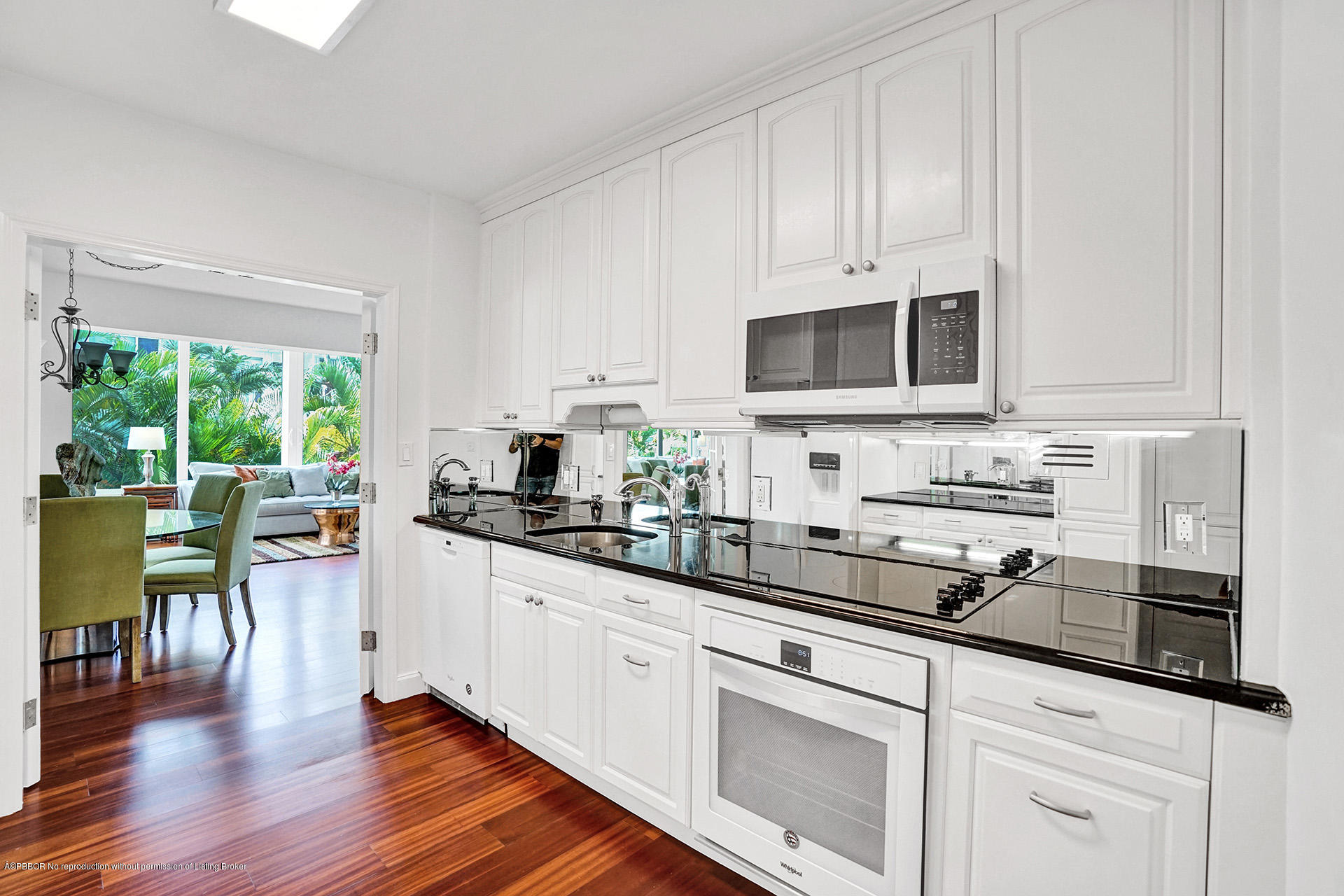 44 Cocoanut Row, Unit 308A Palm Beach, FL 33480 - Photo 10 of 22 a kitchen with stainless steel appliances granite countertop a stove a sink a stove and white cabinets with wooden floor