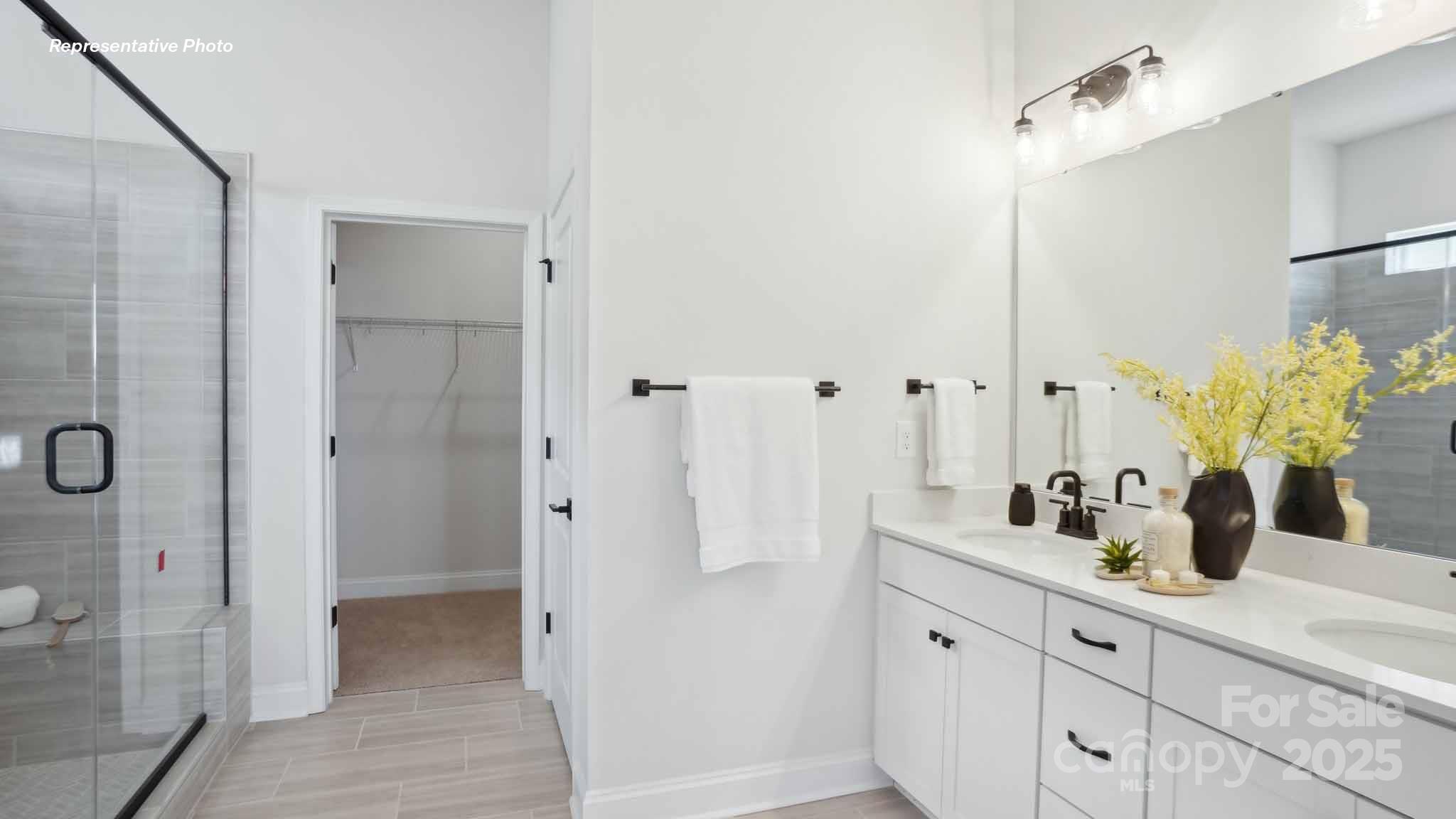 3128 Spring Iris Drive Denver, NC 28037 - Photo 16 of 24 a bathroom with a double vanity sink and shower