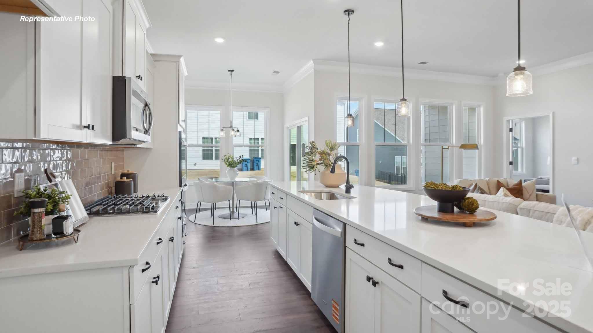 3128 Spring Iris Drive Denver, NC 28037 - Photo 5 of 24 a kitchen with counter top space a sink stainless steel appliances and cabinets