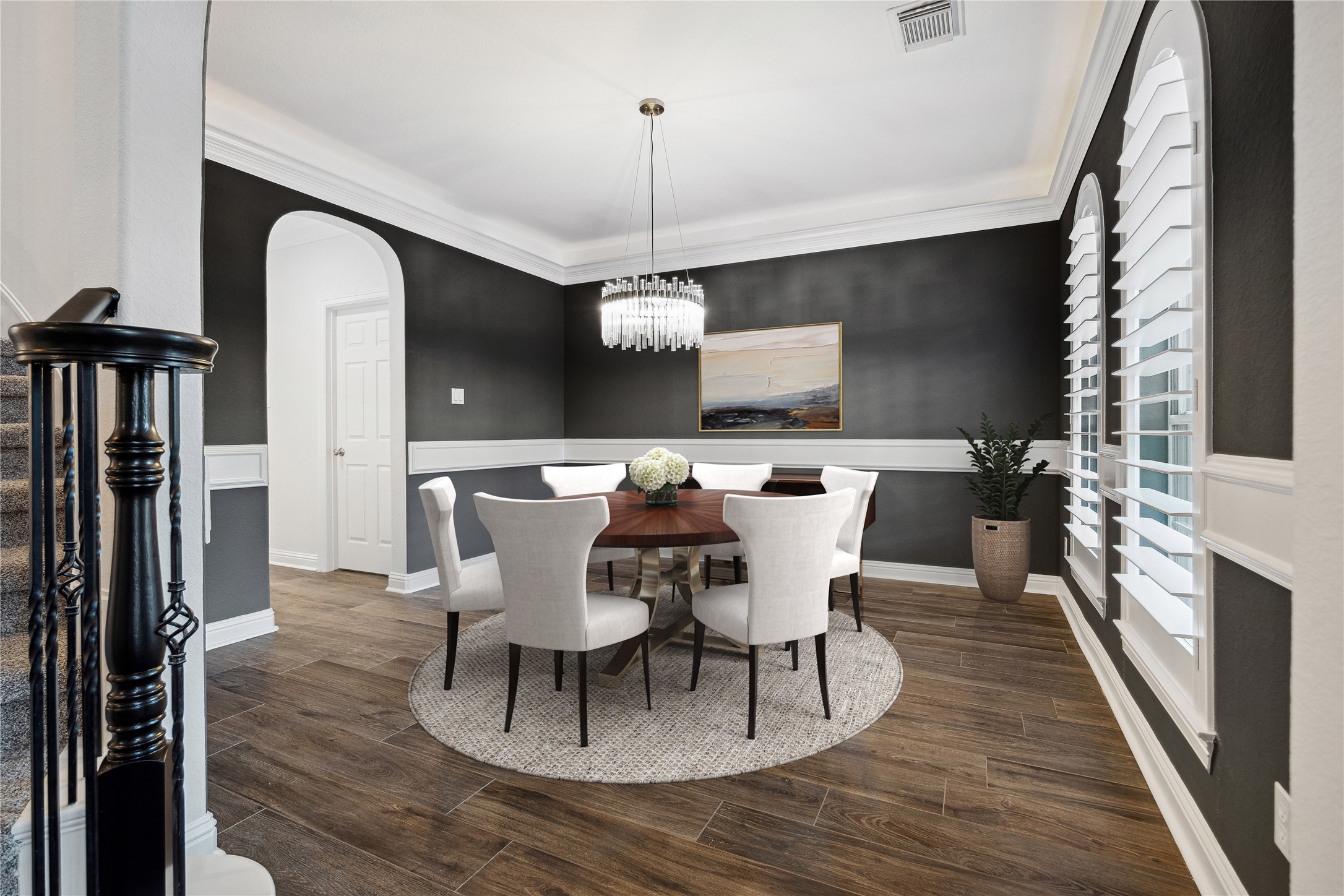 6211 Alameda Point Lane Houston, TX 77041 - Photo 6 of 50 Elegant formal dining room featuring updated lighting, tray ceiling, chair rail details, and classic plantation shutters, perfect for entertaining. *Photo has been virtually staged.