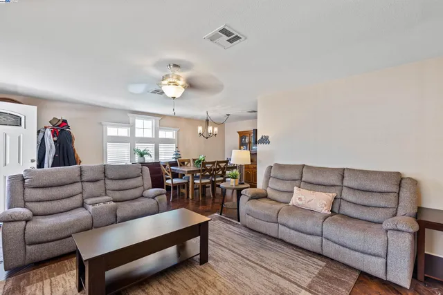 a living room with furniture and a chandelier