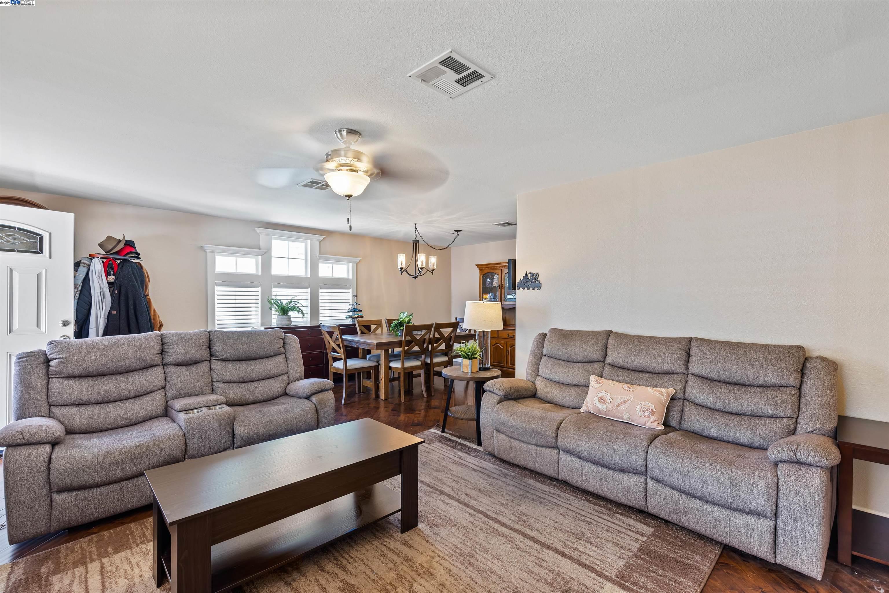 3263 Vineyard Avenue, Unit 89 Pleasanton, CA 94566 - Photo 14 of 41 a living room with furniture and a chandelier