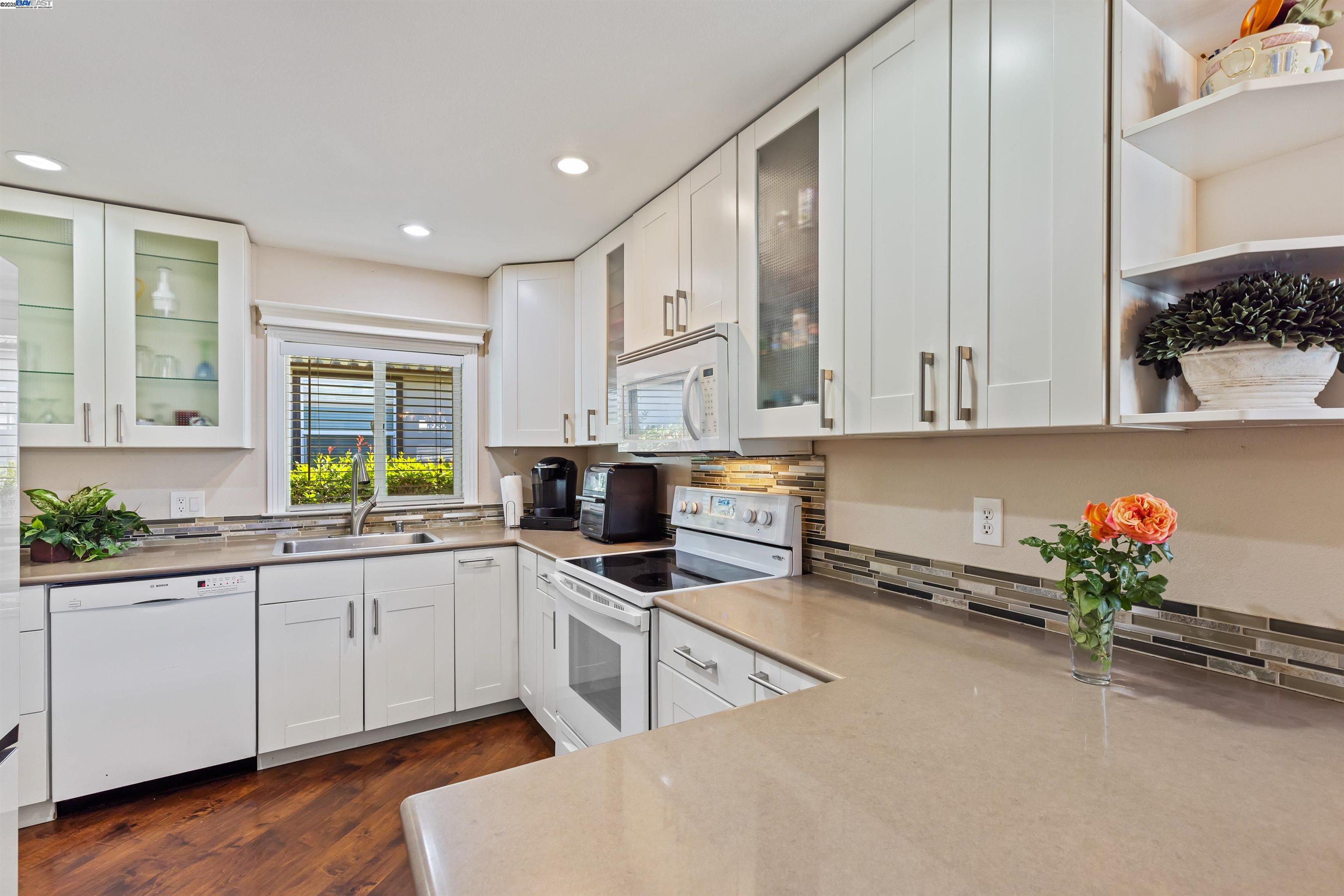 3263 Vineyard Avenue, Unit 89 Pleasanton, CA 94566 - Photo 17 of 41 a kitchen with granite countertop a sink stainless steel appliances and cabinets