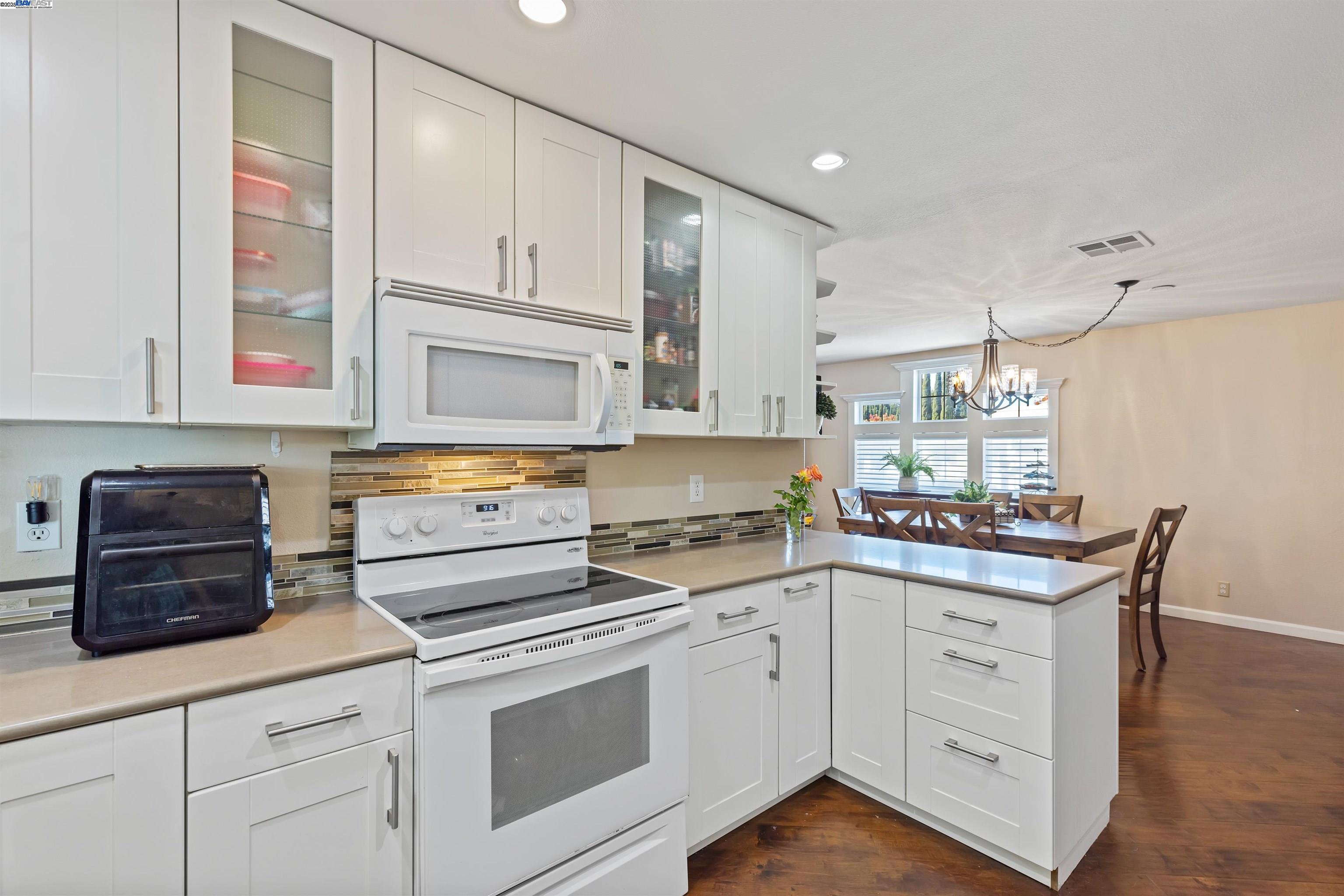 3263 Vineyard Avenue, Unit 89 Pleasanton, CA 94566 - Photo 19 of 41 a kitchen with granite countertop white cabinets and white appliances