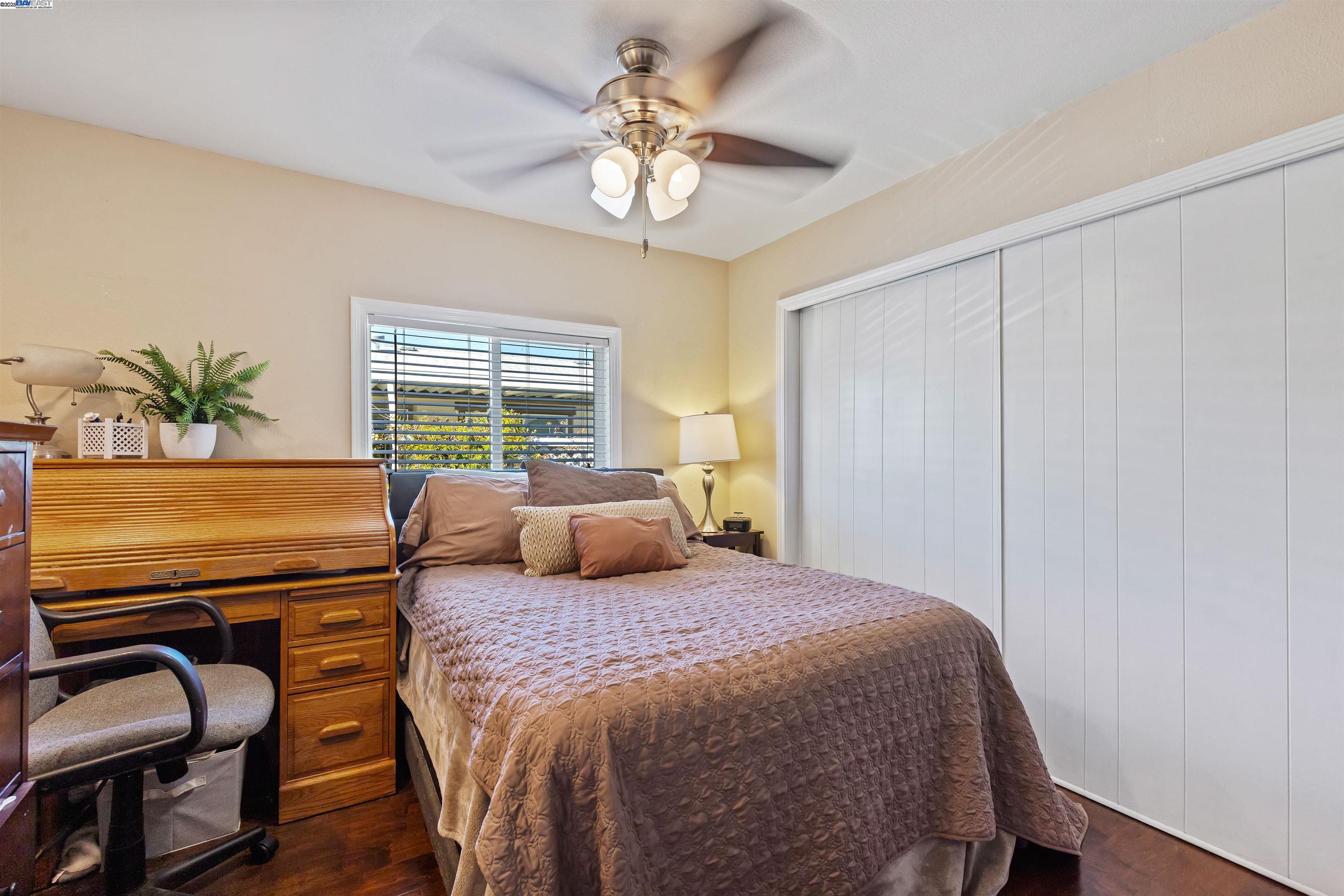 3263 Vineyard Avenue, Unit 89 Pleasanton, CA 94566 - Photo 24 of 41 a bedroom with a bed and a chandelier