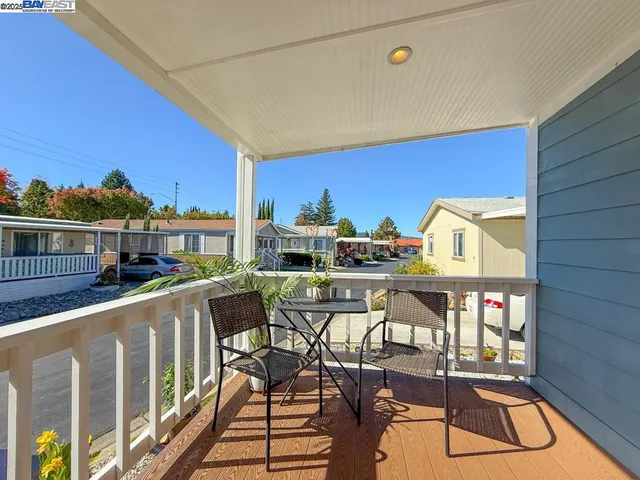 a view of a chairs and table in the balcony