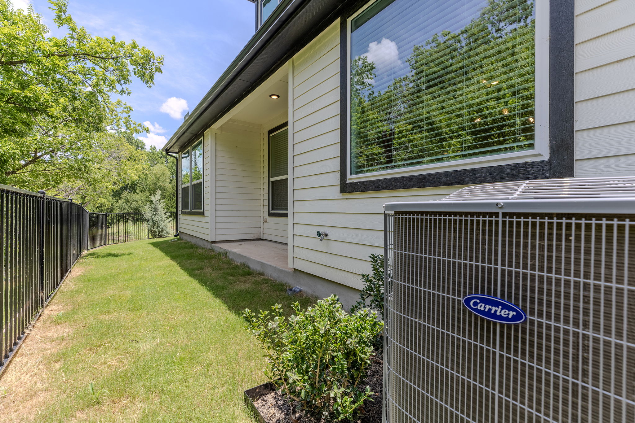 2600 Gattis School Road, Unit 1001 Round Rock, TX 78664 - Photo 32 of 40 A private side yard with a sturdy fence borders the house, offering a tranquil outdoor retreat.