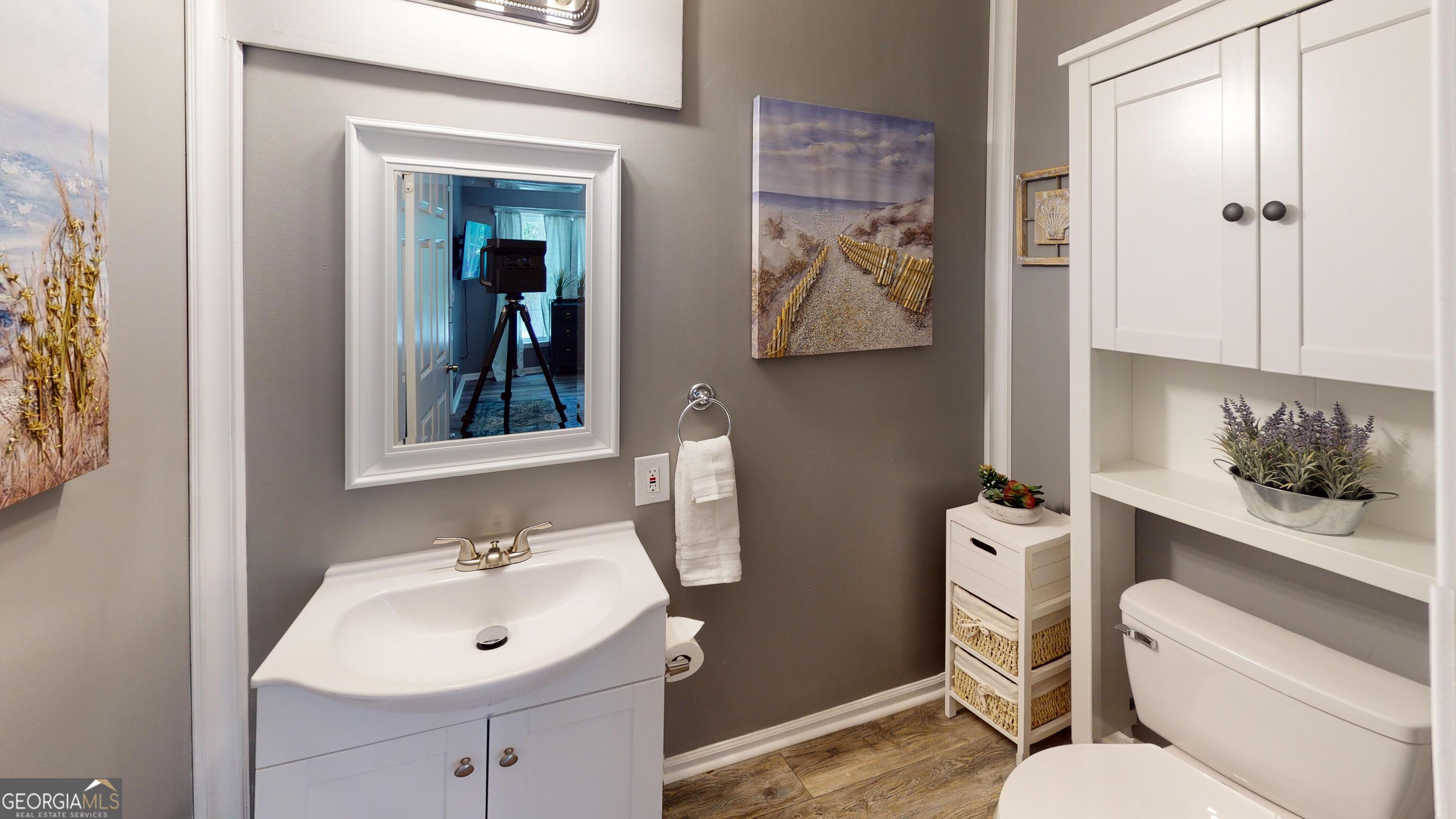 4297 Earney Road, Unit 1 Woodstock, GA 30188 - Photo 9 of 9 a bathroom with a sink mirror vanity and toilet