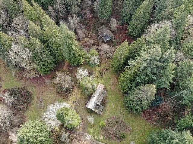 an aerial view of a house with a yard
