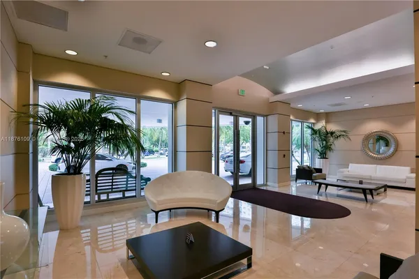 a living room with furniture potted plant and a large window