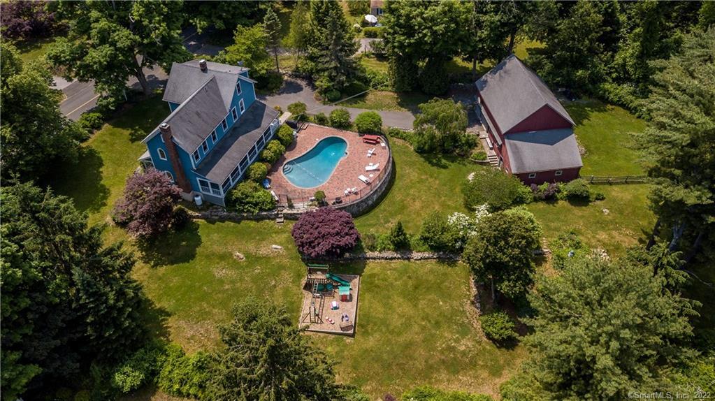 an aerial view of house with yard swimming pool and outdoor seating