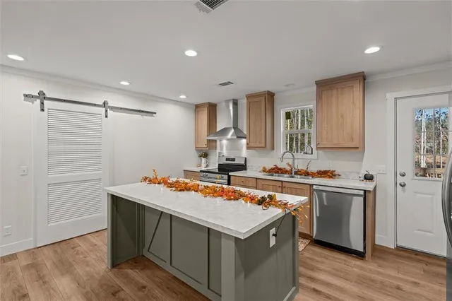 a kitchen with stainless steel appliances granite countertop a stove and a refrigerator
