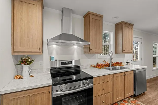 a kitchen with stainless steel appliances a stove sink and cabinets