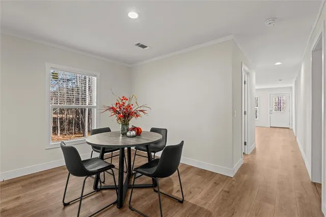 a dining room with furniture and wooden floor