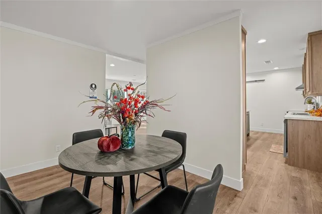 a dining room with furniture and wooden floor