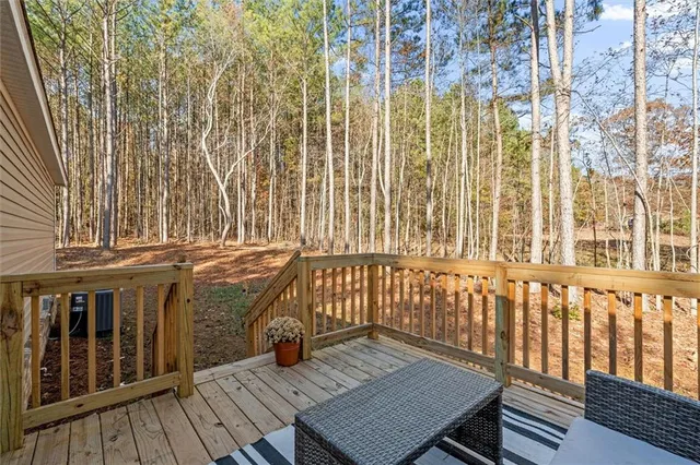 a roof deck with wooden floor and fence