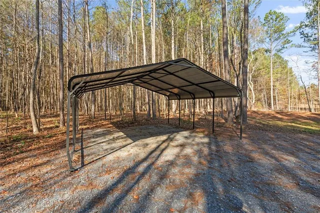 a view of a patio with table and chairs under an umbrella with wooden floor