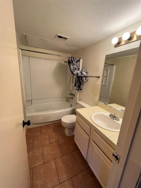 4460 Chaha Road, Unit 205 Garland, TX 75043 - Photo 13 of 27 a bathroom with a sink a toilet and shower