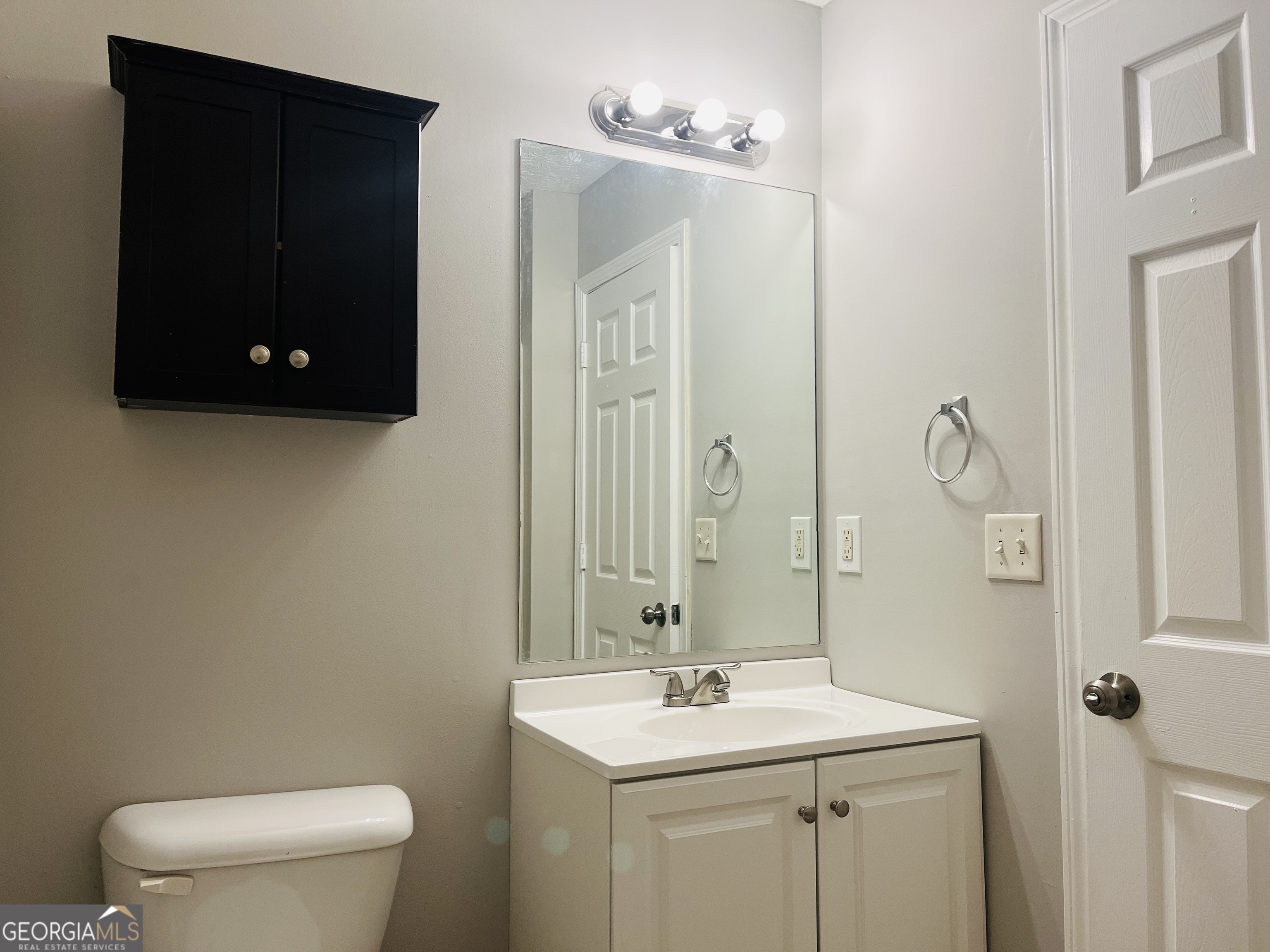 105 Granite Street, Unit B Hogansville, GA 30230 - Photo 15 of 28 a bathroom with a toilet a sink and mirror