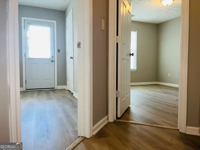 an empty room with wooden floor