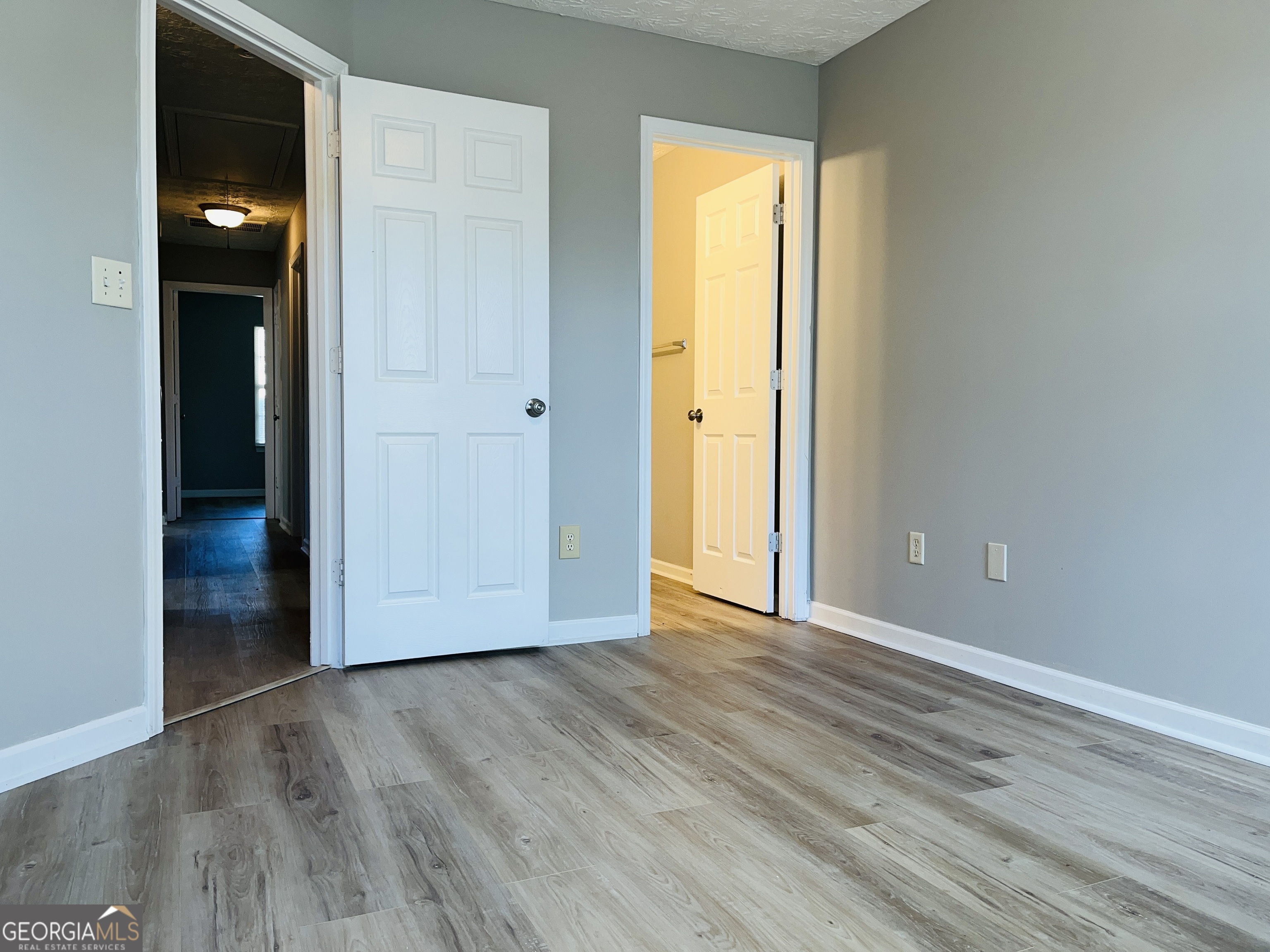 105 Granite Street, Unit B Hogansville, GA 30230 - Photo 20 of 28 an empty room with wooden floor and windows