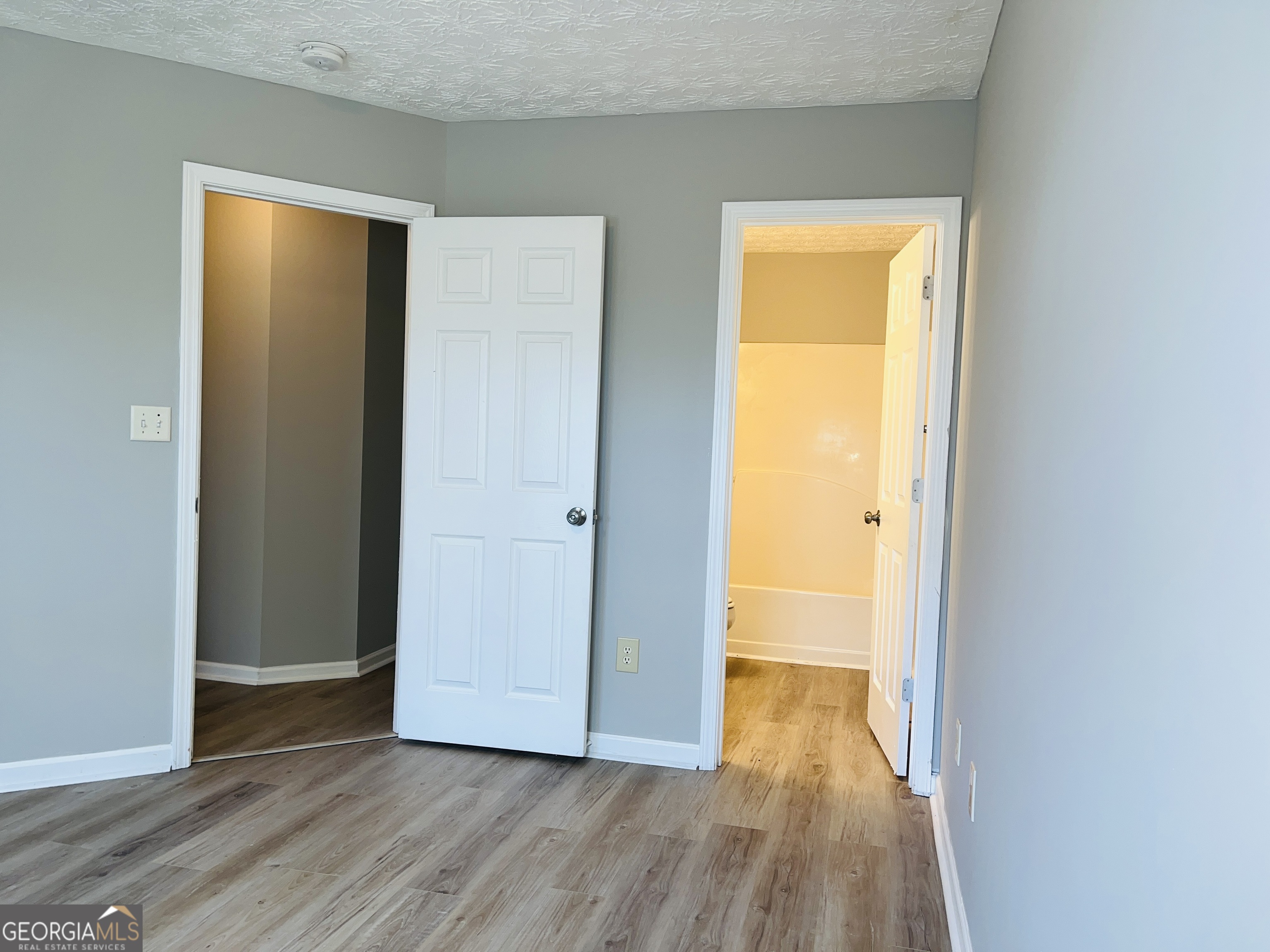 105 Granite Street, Unit B Hogansville, GA 30230 - Photo 22 of 28 a view of an empty room with wooden floor and a window